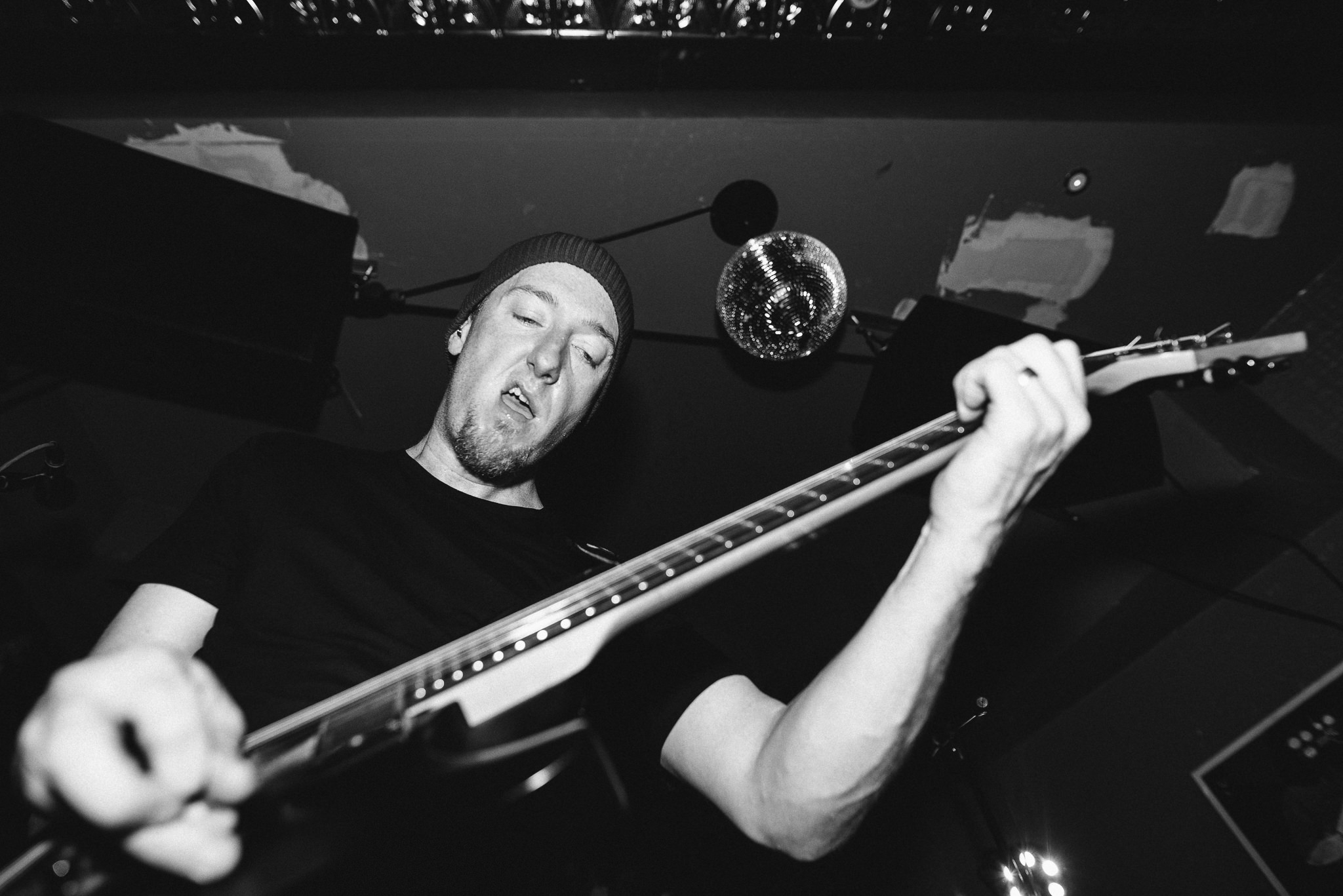 A closeup, black and white shot of Moe playing intensely